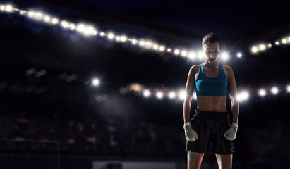 Fototapeta na wymiar Young boxer woman at ring . Mixed media