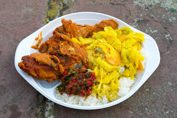 African street food, stew chicken red curry with rice and bamboo shoot on paper plate