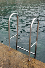 swimming ladder stainless steel for descent into water on concre