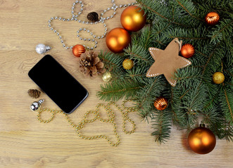 Smartphone and tree branches on the wooden background. Modern co