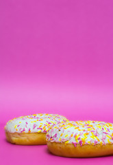 Donuts glazed on a pink background