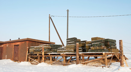Military store ammunition and explosives behind barbed wire in the outdoors in winter