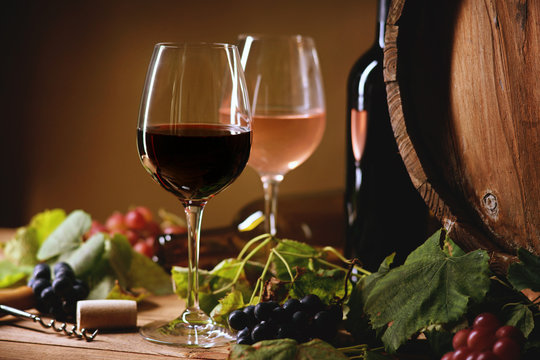 Wine bottle, glasses, grapes and barrel 