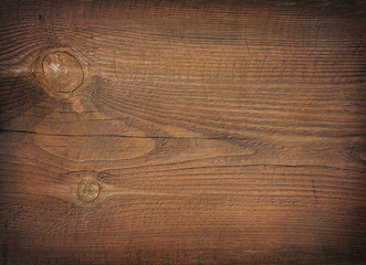 Dark brown scratched wooden cutting board. Wood texture