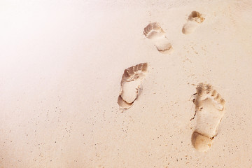 Human Footprints in the Sand Beach leading forward with Natural sunlight, Sand Texture and...