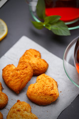 Homemade heart shape cookies and tea on the table