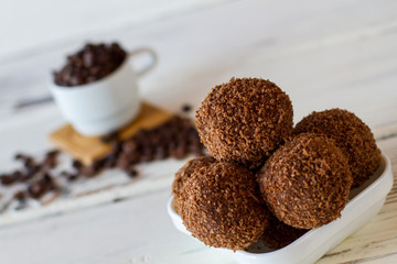 Sweets in a bowl. Brown desserts with crumbs. Delicious chocolate balls. Crumbled cookies mixed with butter.