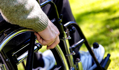 Senior man on the wheelchair outdoor. Detail view
