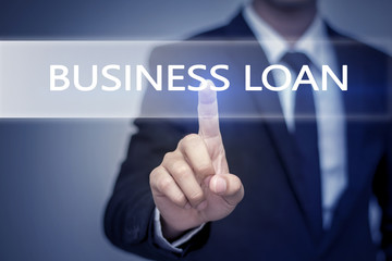 Businessman hand touching  BUSINESS LOAN button on virtual scree