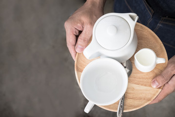 White Coffee Set (coffee cups and milk jug) put on wooden table.