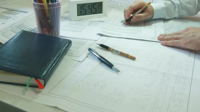 The designer works with drawings of electrical circuits