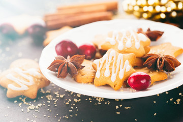 Homemade Christmas gingerbread cookies with festive decoration on dark background, selective focus. Holiday concept, toned