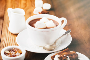 Mug filled Hot chocolate and Marshmallows on old wooden table. Christmas time, selective focus. Holiday concept, toned