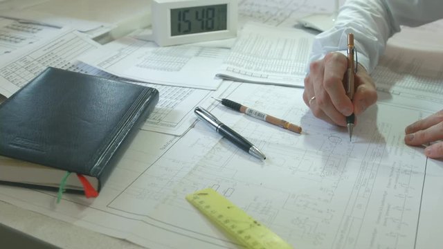 The designer works with drawings of electrical circuits