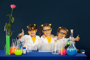 Happy kids doing science experiments in the laboratory.