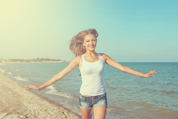 Young cheerful girl on the sea