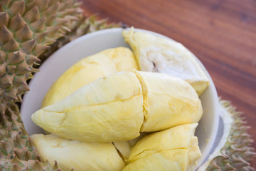Yellow durian in White dish,  Mon Thong durian fruit on woog tab