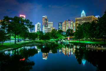 The Uptown skyline and a lake at Marshall Park at night, in Char