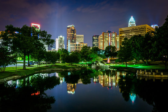 The Uptown skyline and a lake at Marshall Park at night, in Char