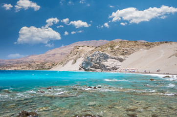 Agios Pavlos Beach in Crete island, Greece. Tourists relax and bath in crystal clear water of St. Paul Sandhill Beach.