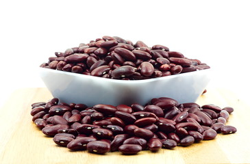 Red bean in white plastic bowl and wooden table. Ingredient bean