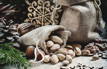 New Year or Christmas composition with walnuts, hazelnuts, pista