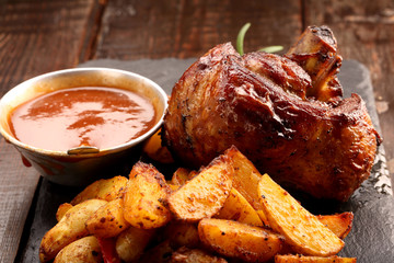 Grilled barbecue meat with baked potato and dip