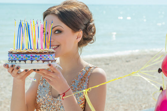 Woman With Balloons And Cake On The Sea