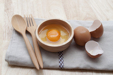Fresh eggs and thai chilli on wood background, selective focus a