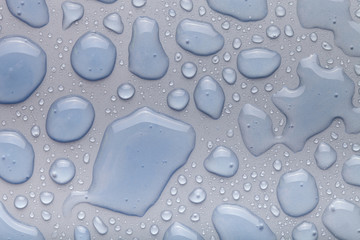Drops of water on a color background. Gray. Shallow depth of fie