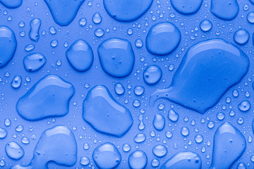 Drops of water on a color background. Blue. Shallow depth of fie