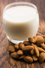 Almond milk with almond on a wooden table