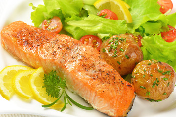 salmon fillet with roasted potatoes and fresh vegetables