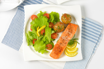 salmon fillet with roasted potatoes and fresh vegetables