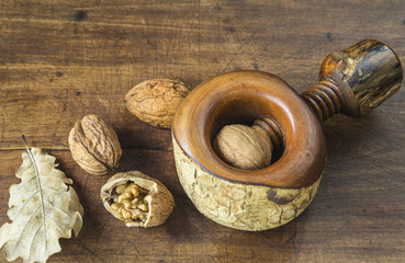Nutcracker and nuts on a wooden background