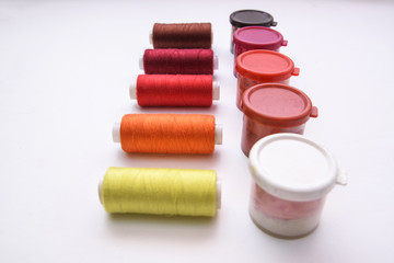 Colored gouache and red gamma threads, for needlework on a white background