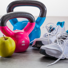 workout concept on grey floor with sneakers and kettle bells © STUDIO GRAND WEB