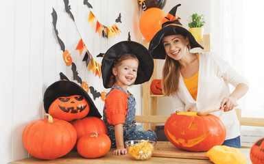 family mother and child daughter in hat witch are preparing for