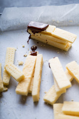 Stack of homemade english shortbread cookies with dark chocolate drips. Selective focus