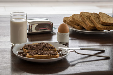Sliced bread with milk and egg in holder