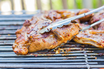 Pork roast with crackling roasting on charcoal grill