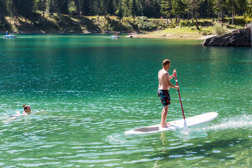 Couple on a paddleboard in Caumasee, Switzerland