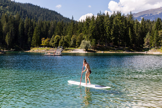 Girl on a paddleboard on the Caumasee in Switzerland