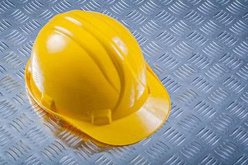 Hard hat on grooved metal plate construction concept