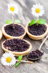 Homemade  chocolate caramel tartlets with poppy seeds and sugar.