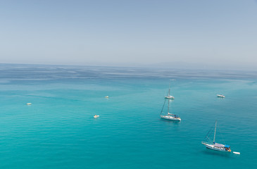 Fototapeta premium Small boats on the crystal clear sea near the town of Tropea region Calabria - Italy 