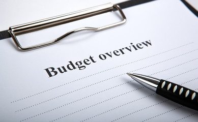 document with title budget overview and pen