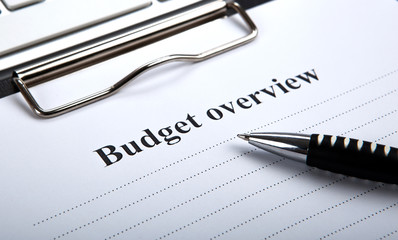 document with title budget overview and pen