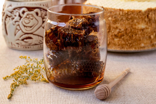 Honeycomb in glass jar. Autumn still life. Close up.