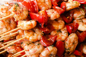 prawns with red pepper on skewers. street trading